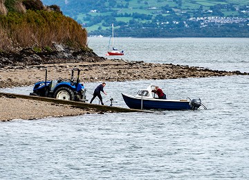 Launching a boat from Gallows Point near Beaumaris