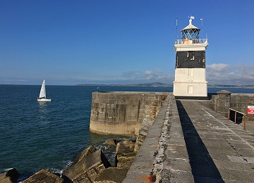 Holyhead Breakwater lighthouse with yacht at side