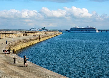 Holyhead Breakwater with Ferry boat leaving and people fishing