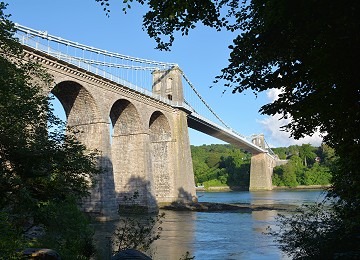 Menai Suspension bridge through trees summer