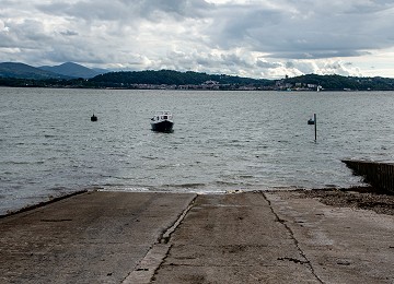 The slipway and boat waiting to be hauled out of the water at Gallows Point near Beaumaris
