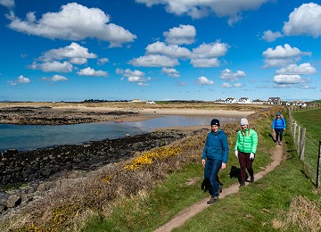 Walkers on The Anglesey Coastal Path next to Porth Nobla