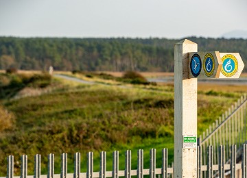 Anglesey Coastal Path sign and the Malltraeth Cob