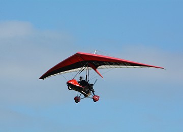 Single seater microlight flying over Menai Strait on Anglesey